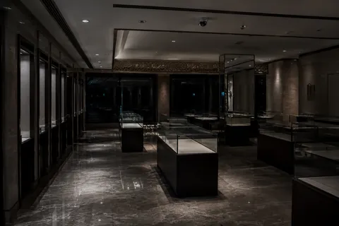 A jewellery showroom after closing, display cases emptied and the shutters down behind them.
